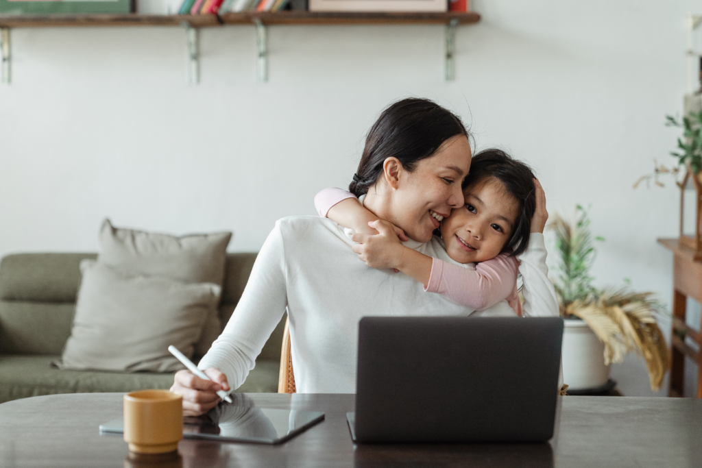 mother and daughter hugging while working