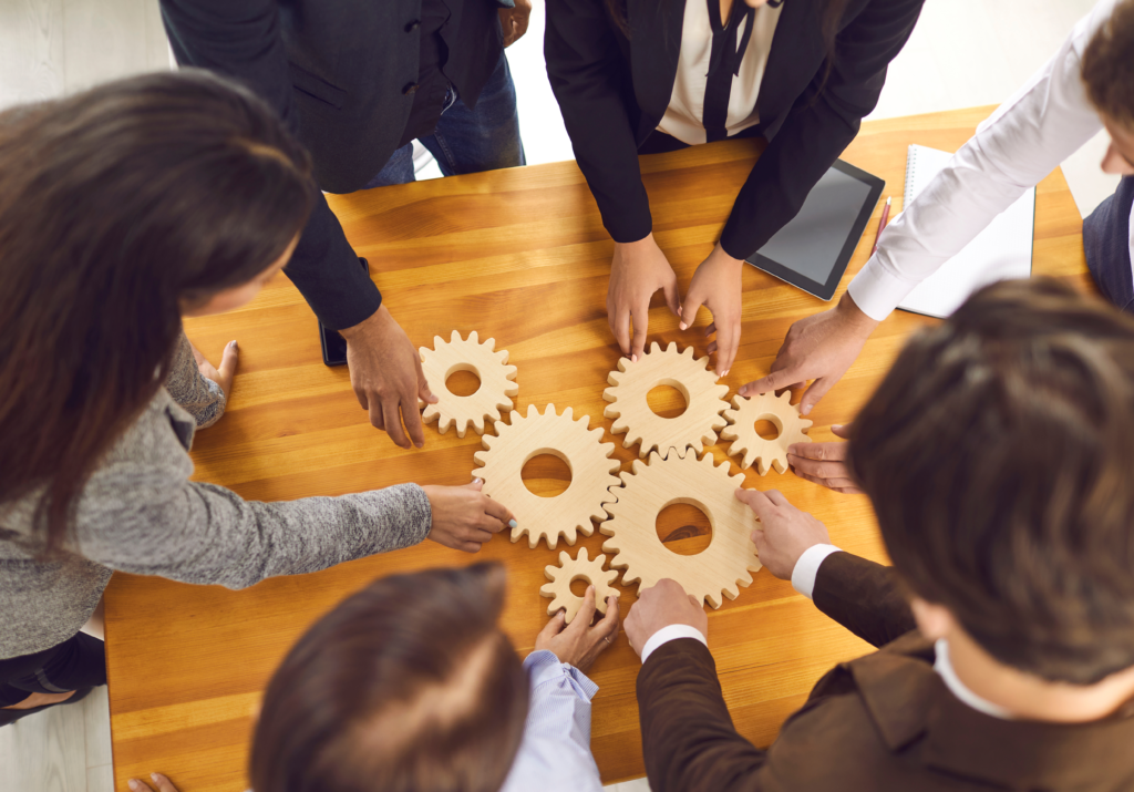 a group of people connecting gears